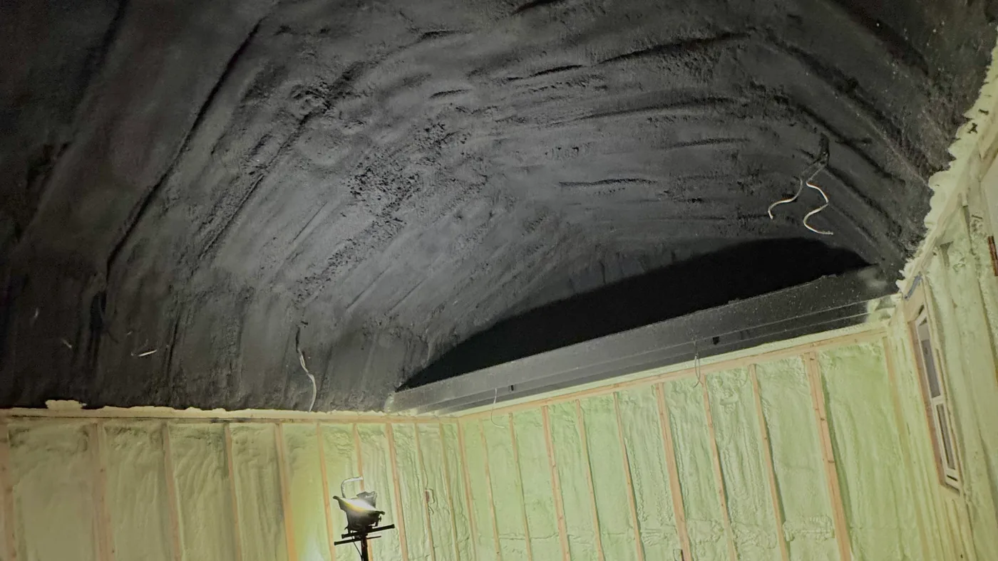 The inside of a steel shop after a full seal, with the walls sprayed and the whole ceiling covered so no bare metal is left showing