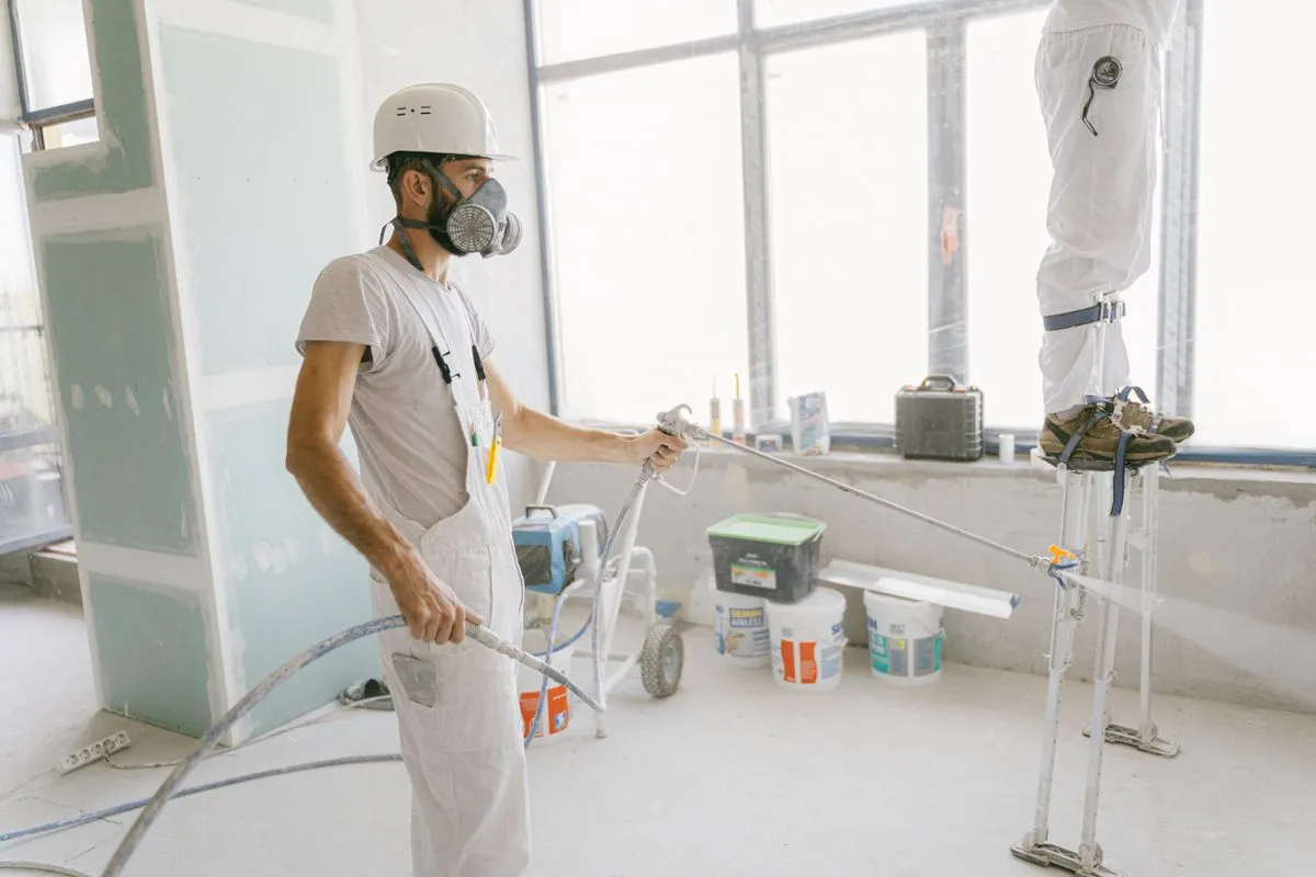 A crew in protective gear spraying closed-cell foam insulation
